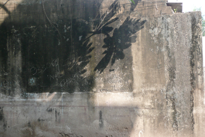 A shadow on the wall opposite the house
