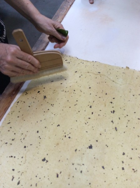 Each sheet is then carefully brushed onto smooth boards and allowed to air dry 